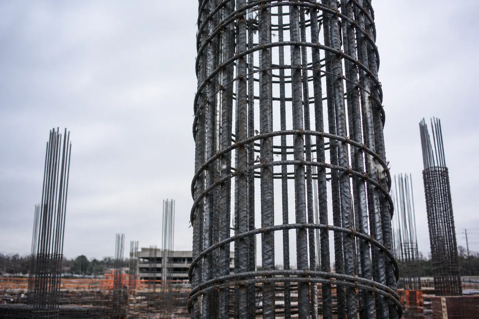 Vertical reinforcing steel cage for a concrete column, with spiral ties, on a commercial jobsite